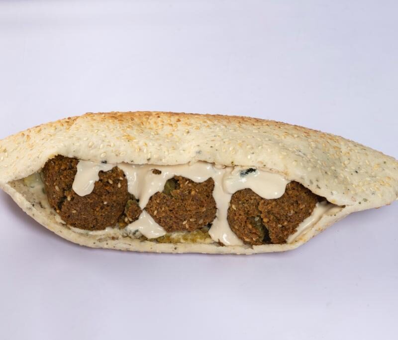 Delicious falafel sesame sandwich with tahini sauce, Middle Eastern cuisine's best flavors - Baba Saj